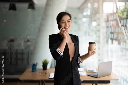 Wallpaper Mural Portrait business asian woman standing while talking with mobile phone. Torontodigital.ca