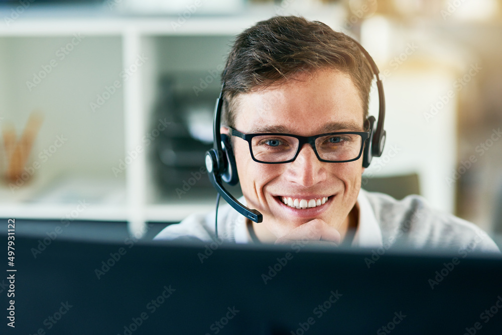 Handling every call with seamless professionalism. Shot of a young call center agent working in an office.