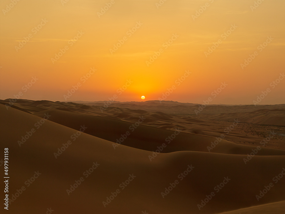 Romantic Desert Sunset in the Rub'al Khali Desert aka The Empty Quarter or Liwa Desert, endless sand dunes in the United Arab Emirates