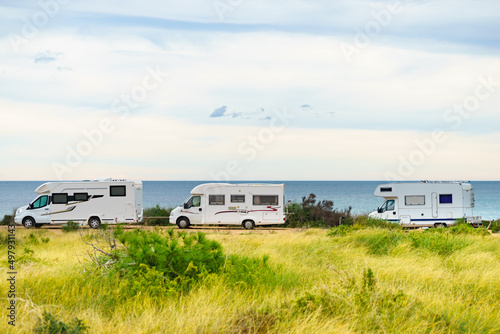 Diverse camper cars on beach sea shore