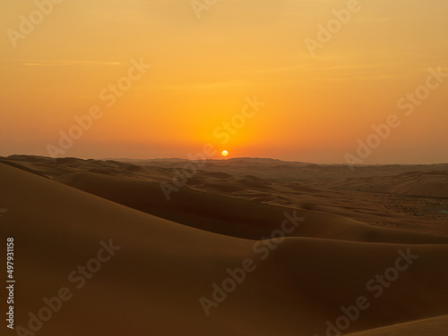 Romantic Desert Sunset in the Rub'al Khali Desert aka The Empty Quarter or Liwa Desert, endless sand dunes in the United Arab Emirates