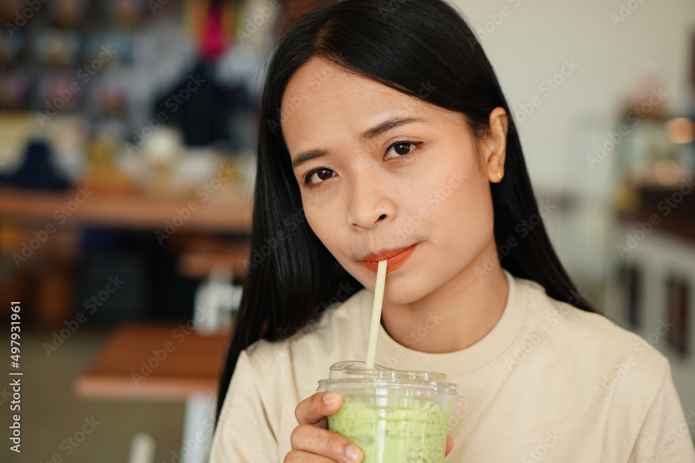 Asian woman smiling happily in a cafe Asian woman smiling happily in a cafe