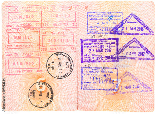 Opened depersonalized Russian passport with stamps on border crossing. Departure and arrival immigration stamps. Passport page with the immigration control. Russia  Turkey and Thailand customs stamps