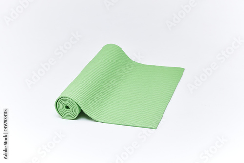 Green Yoga Mat With White Background. Green Yoga Mat on a white background. Close up view at exercise green mat isolated on the white. 