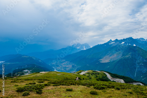 Mountain valley with snow peaks and clouds in Tetnuldi