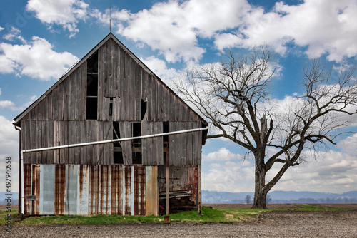 Rural countryside farm landscape with aging dilapidated barn