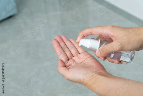 Woman hands using hand sanitizer gel
