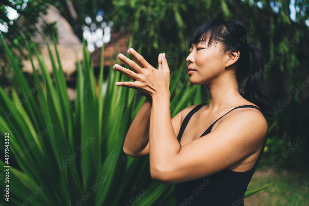 Asian girl practicing yoga and meditating outdoor Asian girl practicing yoga and meditating outdoor