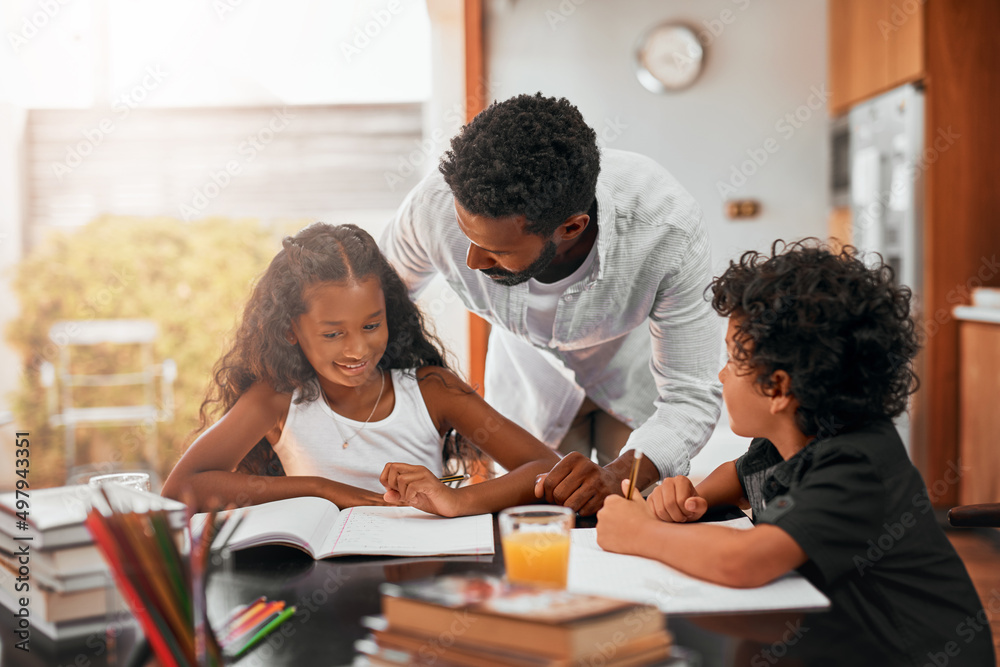 Set a regular schedule for completing homework. Shot of a dad helping his children with their homework. Set a regular schedule for completing homework. Shot of a dad helping his children with their homework.