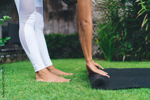 Girl preparing fitness mat for exercise or yoga
