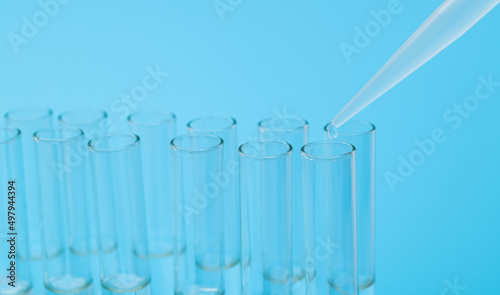 Liquid drop to test tube on blue background