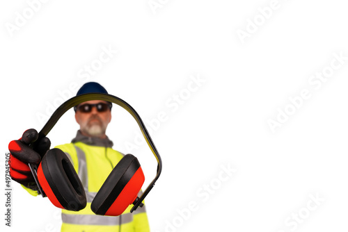 A construction worker in a hi-viz coat and black safety gloves giving ear defenders to viewers isolated on white background. 