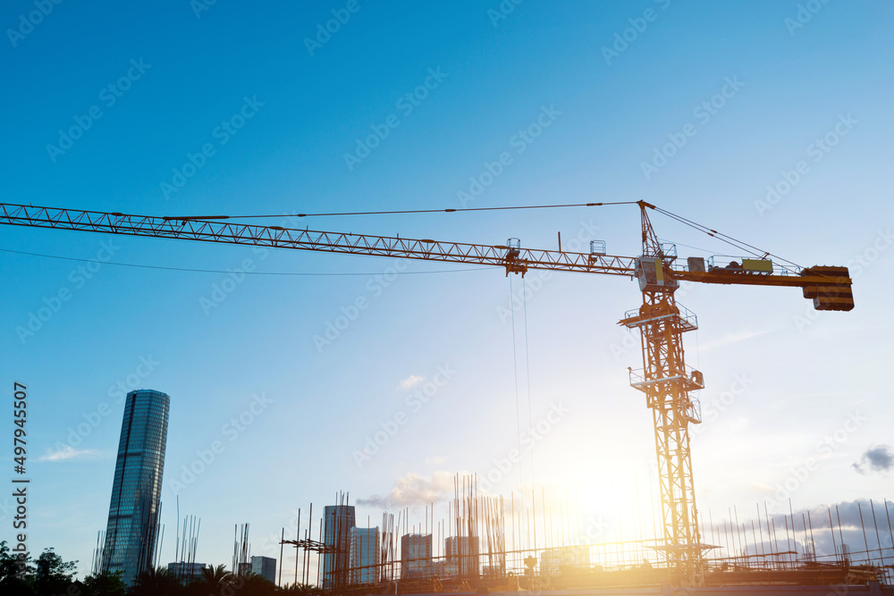 Building construction site with crane under blue sky