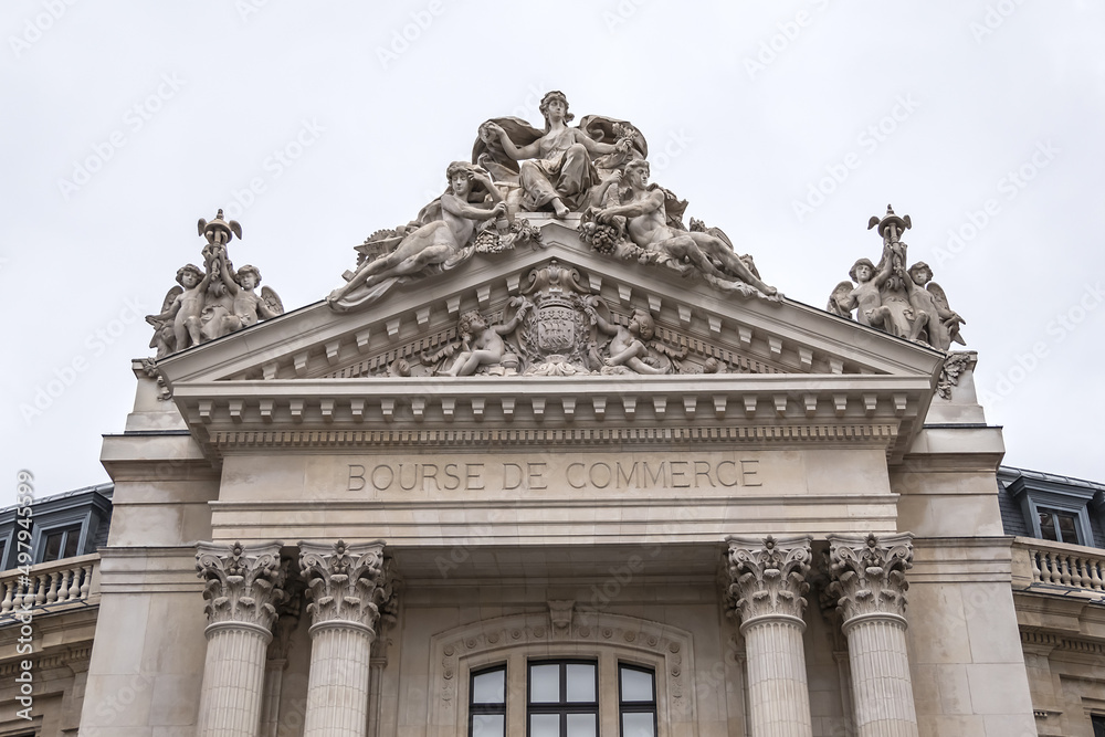 Architectural details of old Paris buildings: Bourse de Commerce (Commodities Exchange), circular building has a history dating back to XVI century. Current building dates back to 1886. Paris. France.