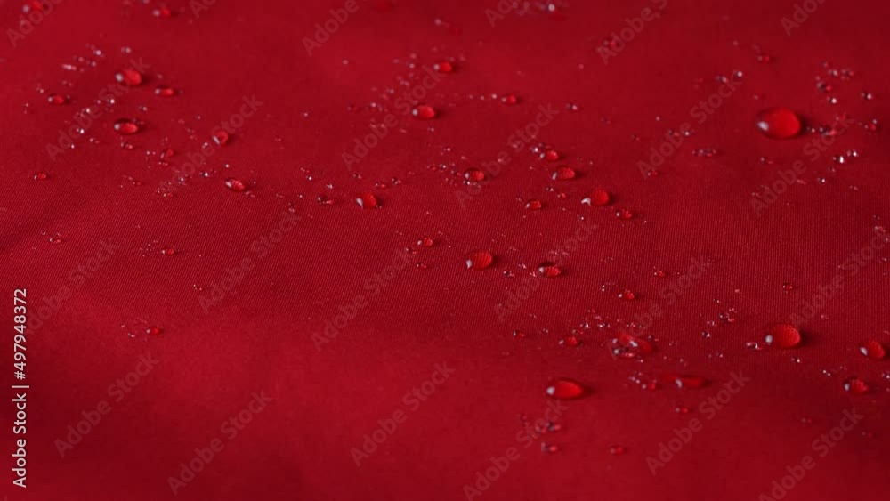 Waterproof textile cloth concept. Rain, water drops are splashing on coat but waterproof is saving from be wet. Waterproof textile cloth concept. Rain, water drops are splashing on coat but waterproof is saving from be wet.