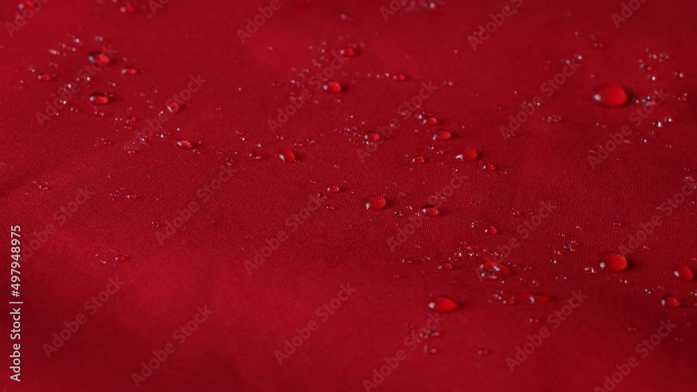 Waterproof textile cloth concept. Rain, water drops are splashing on coat but waterproof is saving from be wet. Waterproof textile cloth concept. Rain, water drops are splashing on coat but waterproof is saving from be wet.