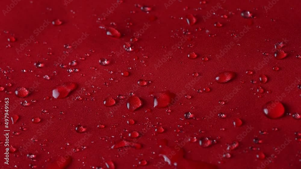 Waterproof textile cloth concept. Rain, water drops are splashing on coat but waterproof is saving from be wet. Waterproof textile cloth concept. Rain, water drops are splashing on coat but waterproof is saving from be wet.