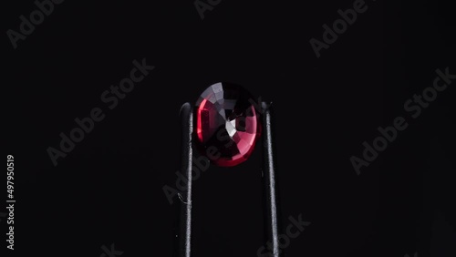 natural red spinel oval gem stone on the turning table photo