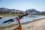Mountain bike city trip in Salzburg. Close up of handle bar outdoors, summer day, city mobility