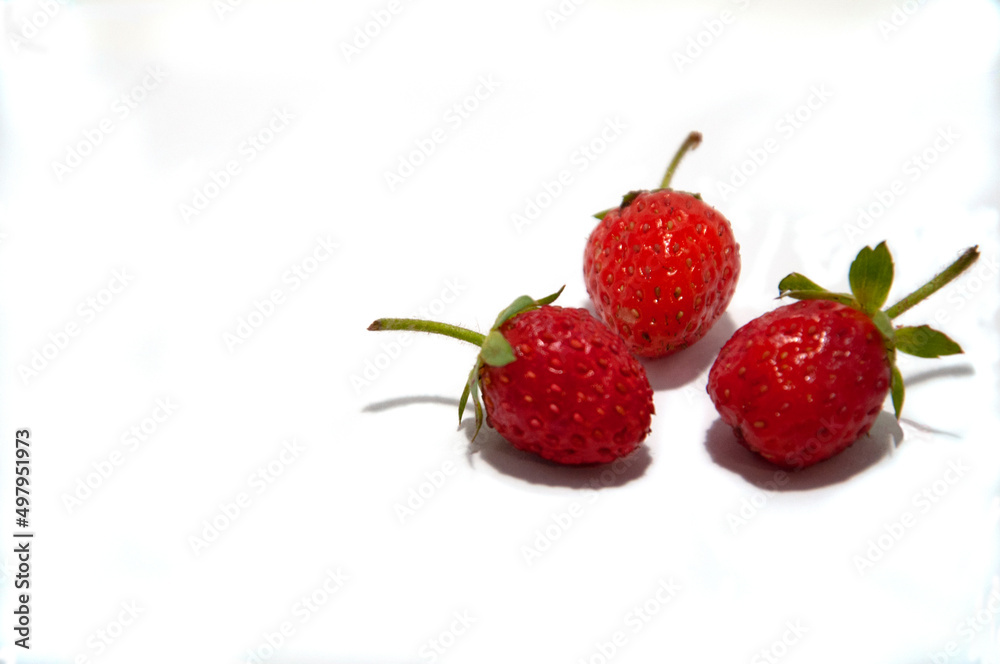 Strawberries lie in a circle in the form of a flower on a white background. High quality photo Strawberries lie in a circle in the form of a flower on a white background. High quality photo