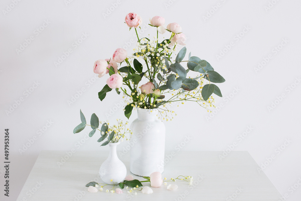 bouquet of pink roses in two white vases on white background bouquet of pink roses in two white vases on white background