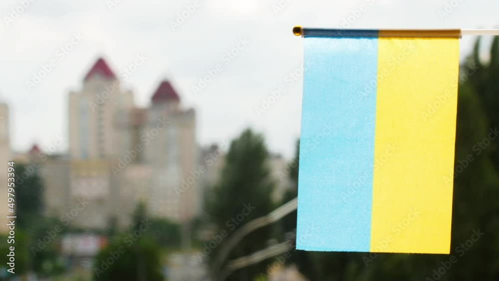 Vidéo Stock Vertically flag of the Ukraine set against blue sky and