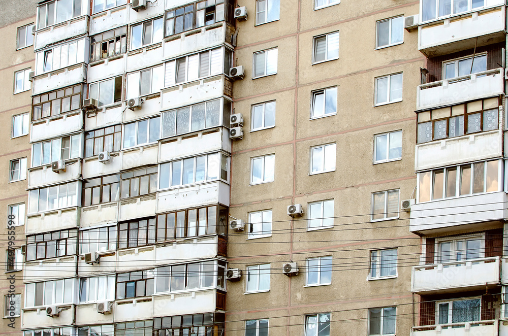 Multi-storey panel residential building with balconies, close-up. The concept of architecture in Russia. Multi-storey panel residential building with balconies, close-up. The concept of architecture in Russia.