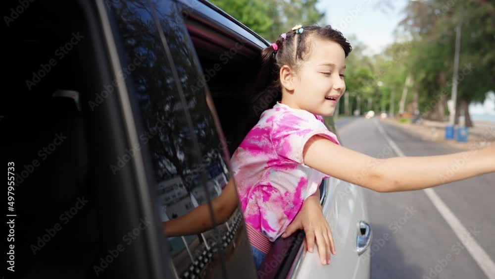 4K Little Asian child girl sitting in the car with pull her face and hand out of the window in summer sunny day. Happy Asian family enjoy and fun together with outdoor lifestyle on road trip vacation 4K Little Asian child girl sitting in the car with pull her face and hand out of the window in summer sunny day. Happy Asian family enjoy and fun together with outdoor lifestyle on road trip vacation