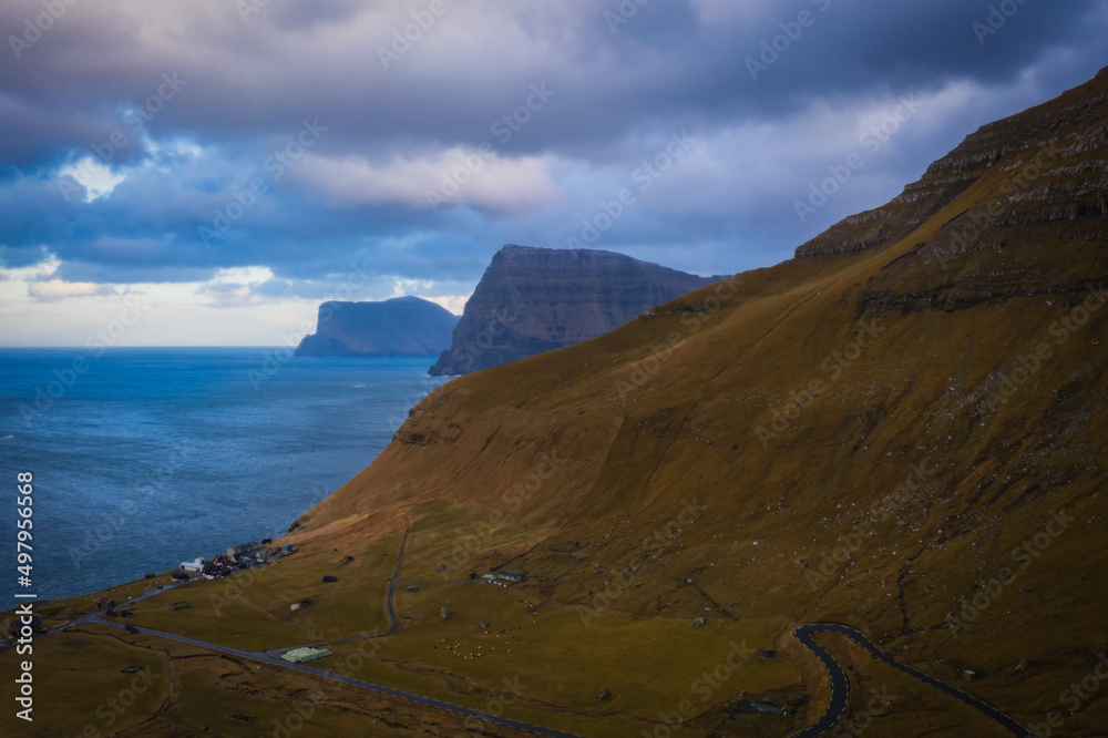 Small village of Trollanes near Kallur lighthouse on Kalsoy island in daytime, Faroe Islands, Denmark. Landscape photography. November 2021