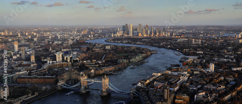 Sunset panorama of London with the most iconic symbol of London, Tower Bridge illuminated by the last rays of the sun before sunset.