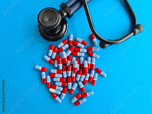 Medical cardiological tablets stethoscope on blue background