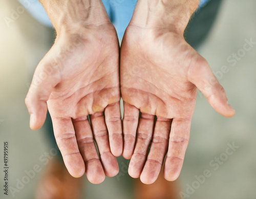 Can you help me please. Closeup shot of an unrecognizable man standing with his hands cupped together.