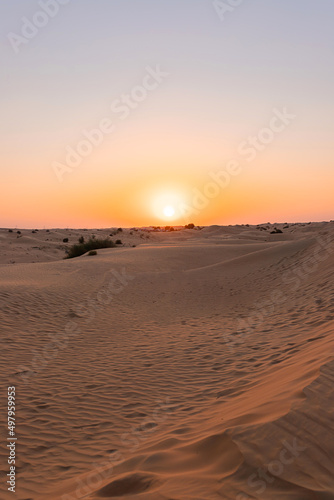 Desert sunset with empty dunes in Dubai or Abu Dhabi, United Arab Emirates