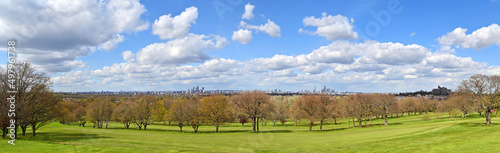 Panorama of London seen from Sydenham Hill in Dulwich. L-R: Croydon, Elephant and Castle, and City of London. Trees, grass, blue sky and clouds. photo