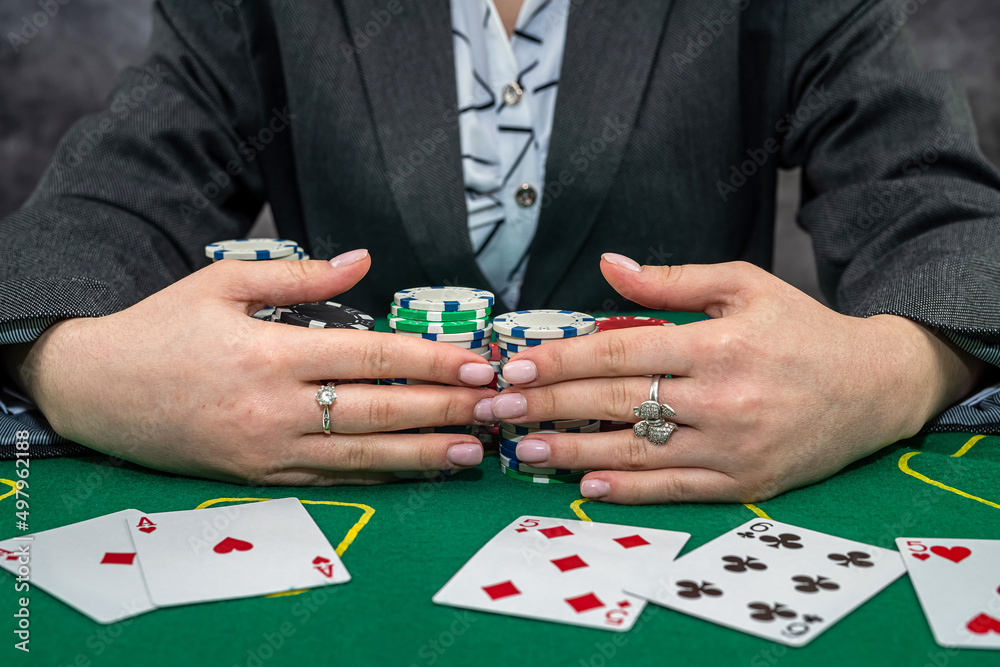 woman wear suit holding chips in casino woman wear suit holding chips in casino