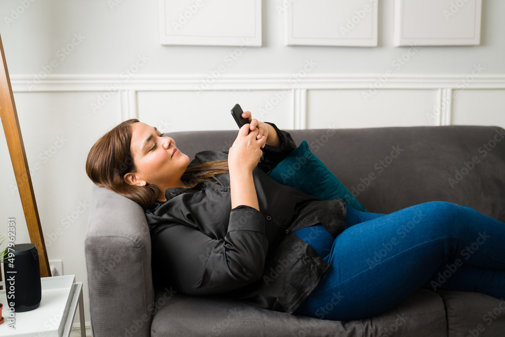 Overweight woman using her smartphone Overweight woman using her smartphone