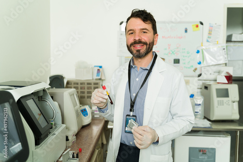 Happy biochemist using a blood sample
