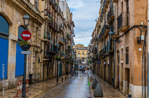 A view down a balconied side street in the city of Tarragona on a spring day