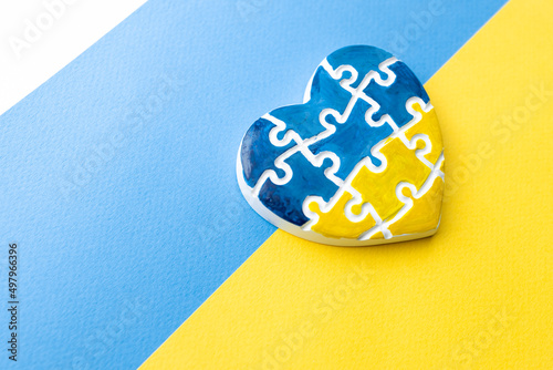 Heart in the form of puzzles with the colors of the flag of Ukraine