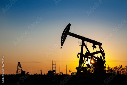 A silhouette of an oil pump at work photo