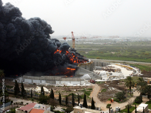 Acre, Israel - April 8 2022: Bahai construction site caught fire and huge smoke pillar covering residential neighborhood 