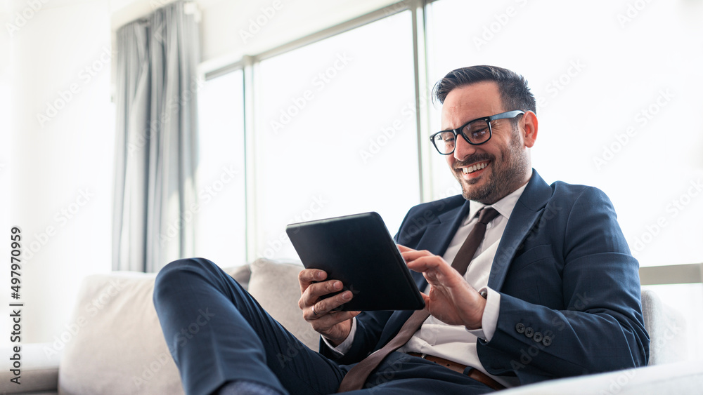 Businessman reading mails on a tablet Businessman reading mails on a tablet