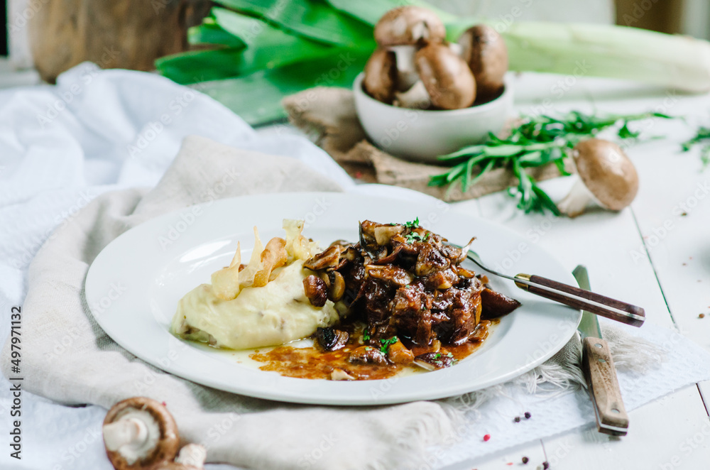 Braised pork with mushrooms and mashed potatoes. Restaurant serving Braised pork with mushrooms and mashed potatoes. Restaurant serving