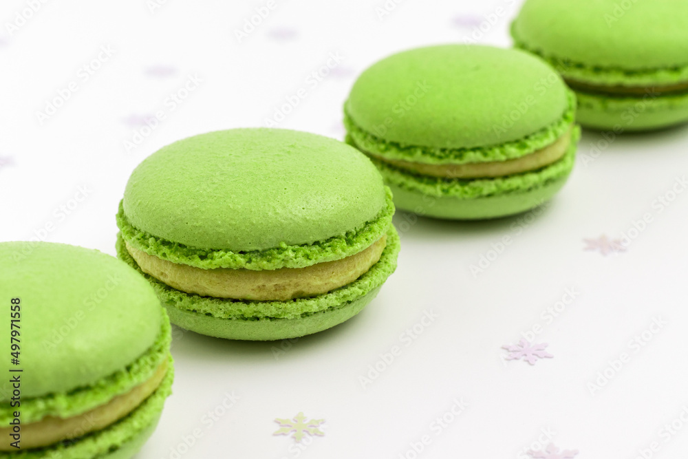 Pistachio Macarons on white background close up. Pistachio Macarons on white background close up.