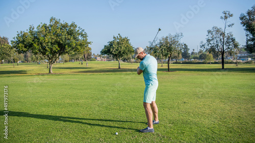 male golf player on professional course with green grass, golf