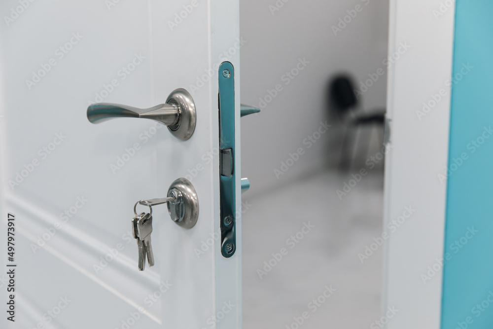 White room door with handle and key White room door with handle and key