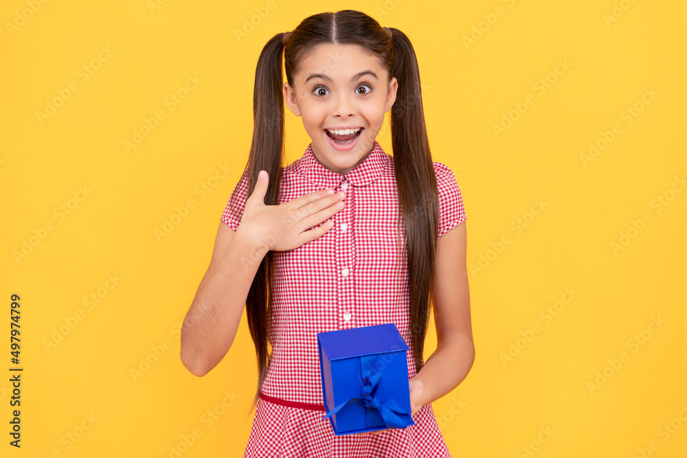 surprised teen girl hold present box on yellow background, surprise surprised teen girl hold present box on yellow background, surprise