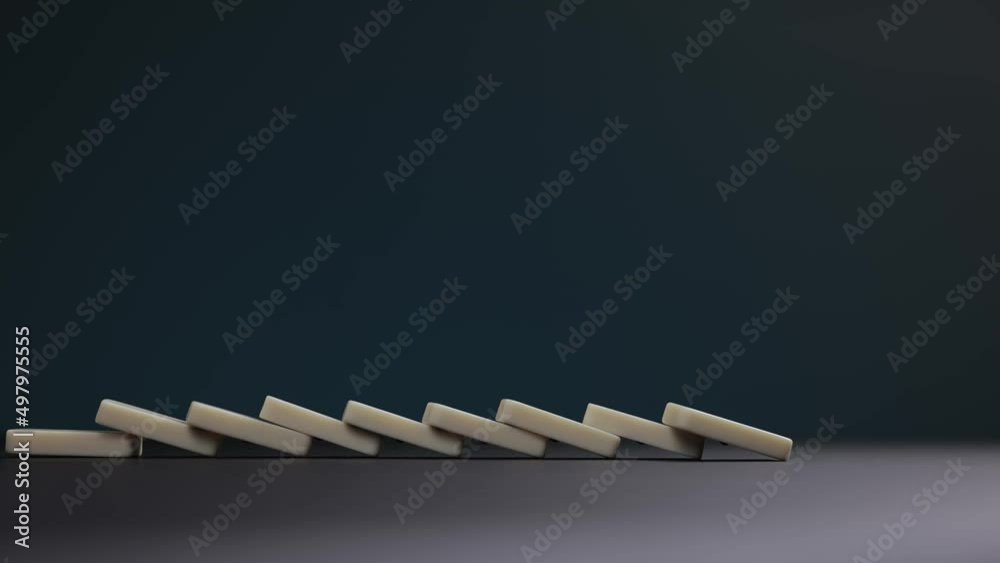 Falling dominoes. Chain reaction, built figure of dominoes falling in slow motion.