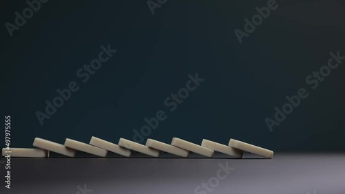 Falling dominoes. Chain reaction, built figure of dominoes falling in slow motion.
