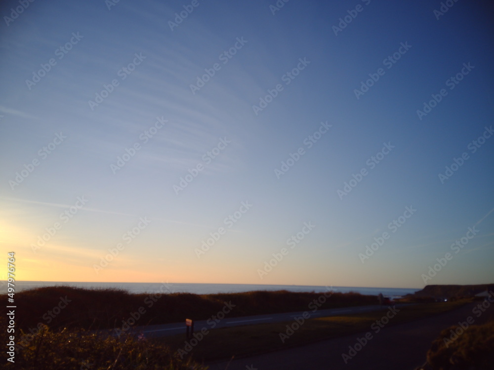 Dusk, sunset sundown, blue sky airplane trails sea coast